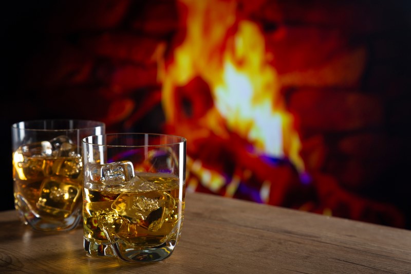 Whiskey on the rocks in front of a fire